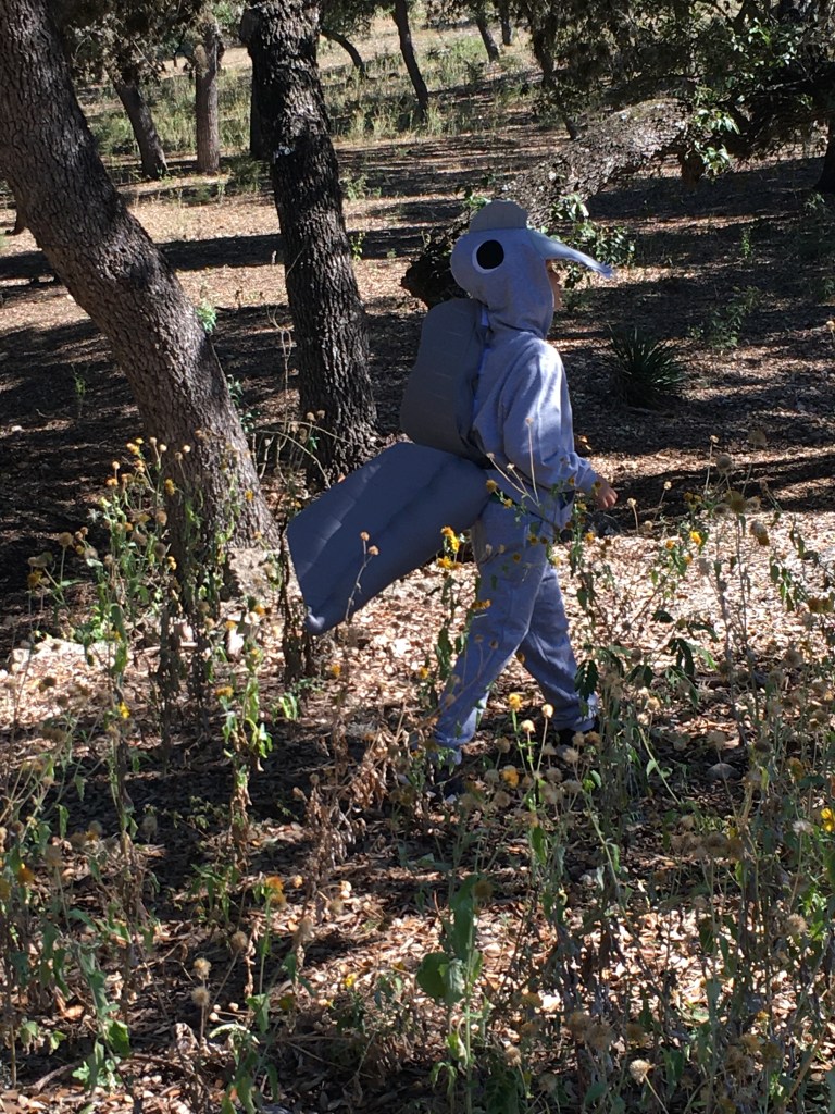 Joey the Spinosaurus stalks through the little woods behind our house.
